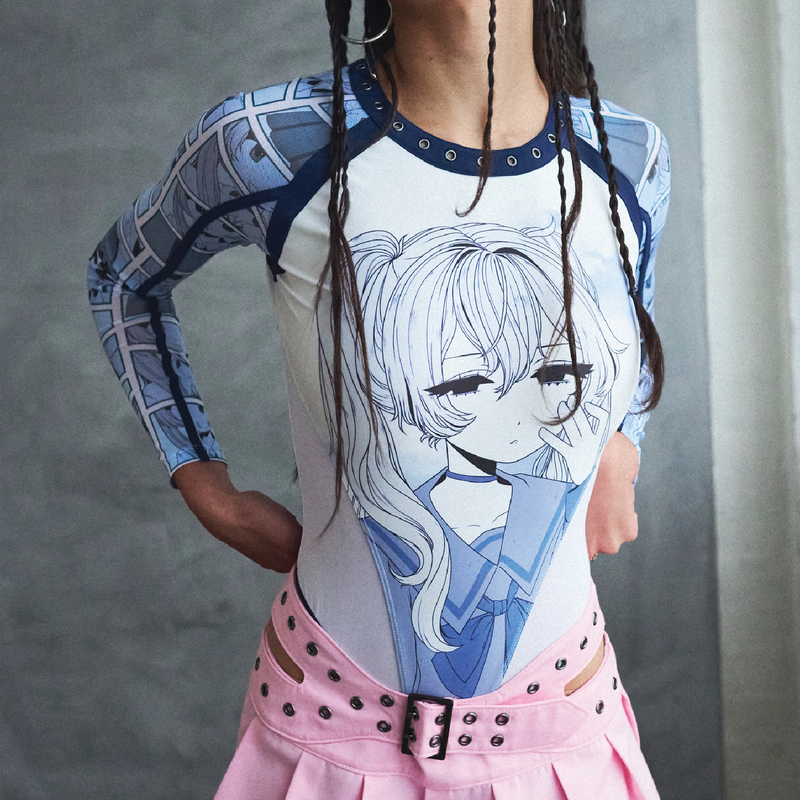Person wearing a long-sleeve shirt with an anime character design and a pink skirt.