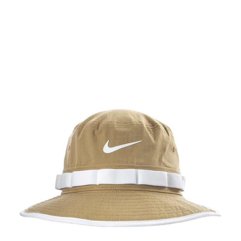 Nike Dri-Fit Apex bucket hat in tan with white band and Swoosh logo.