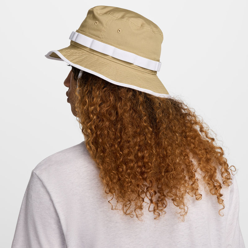 Tan bucket hat back view with white band and wide brim trim.