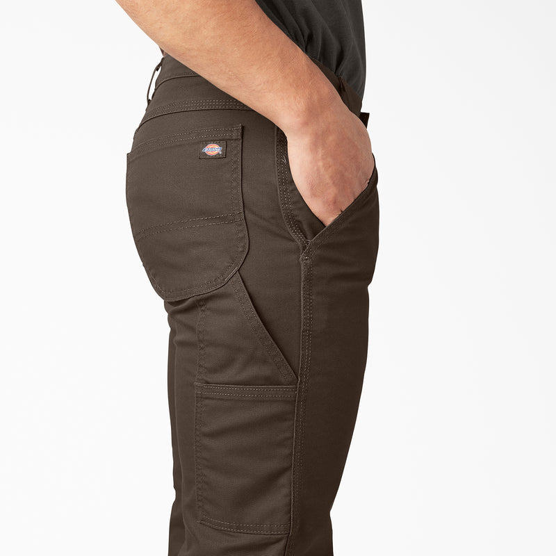 Dark brown canvas carpenter pants with side cargo pockets and small logo patch.