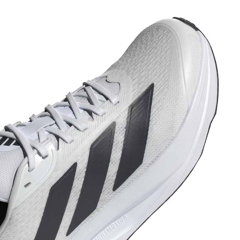 Men's white running shoe close-up, black stripe detail and textured upper