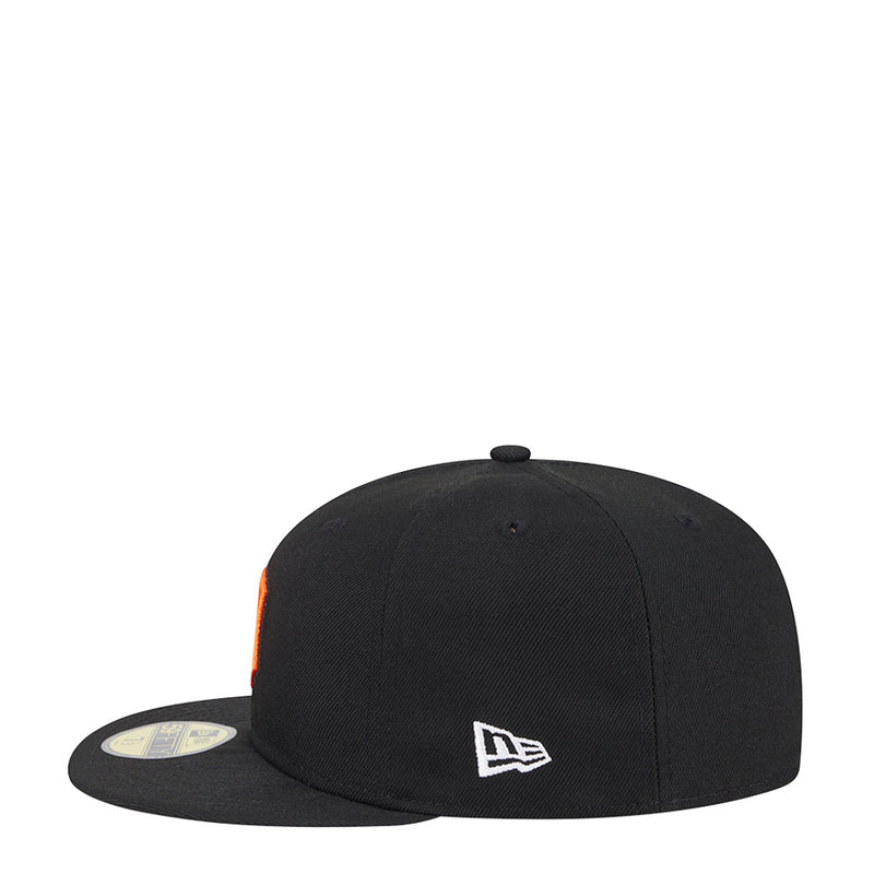 Black baseball cap with New Era logo on front and orange under-brim accent