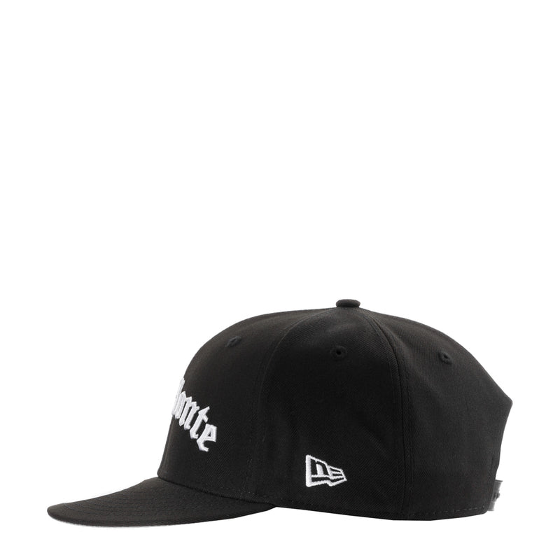 Black baseball cap with white logo patch and New Era-style flag emblem