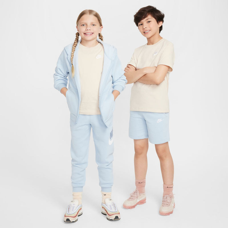 Youth sandrift embroidered tee with chest Nike logo, paired with light blue shorts