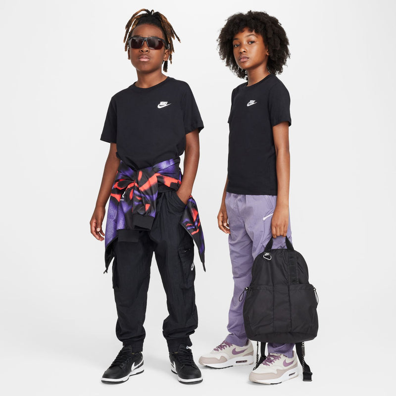 Youth black t-shirt with embroidered Nike logo, worn with loose pants