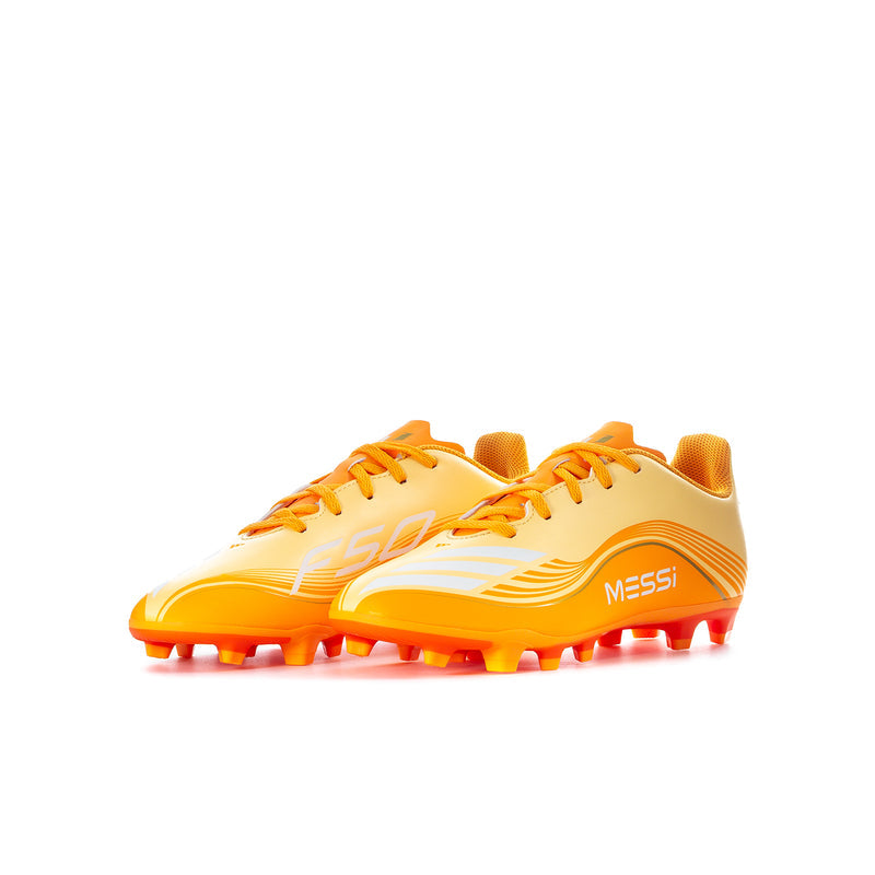 Youth soccer cleat, light yellow upper with orange laces and studs, 'Messi' text on side.