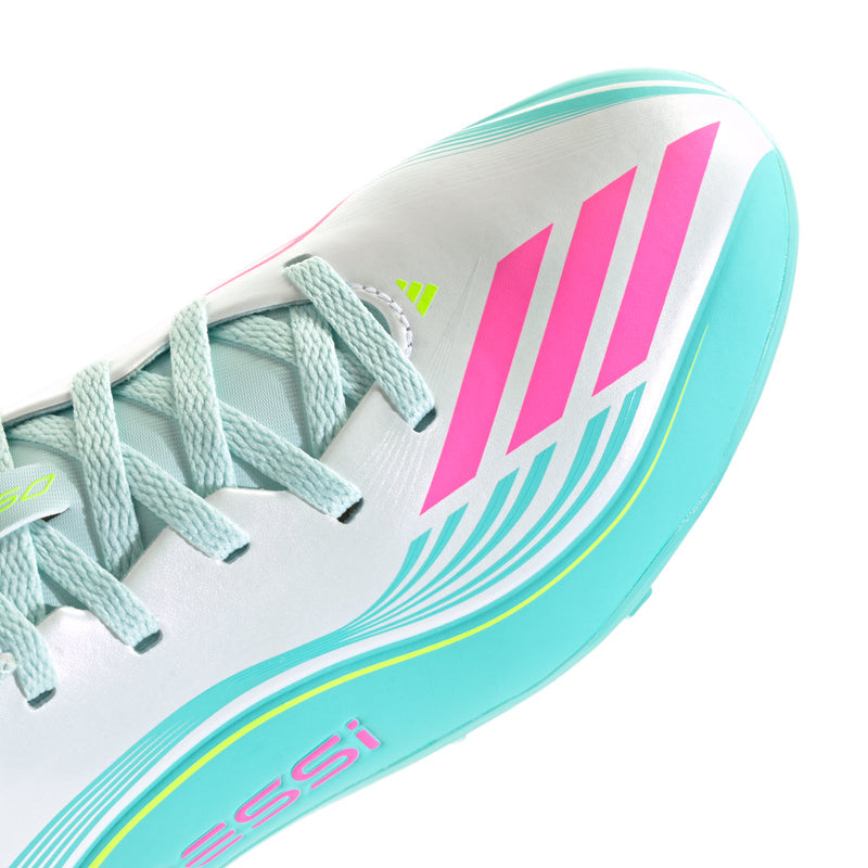 Youth soccer cleats close-up of side panel, turquoise stripes and pink detail