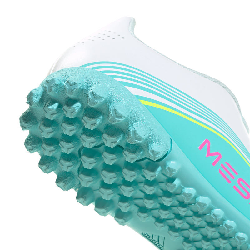 Youth soccer cleats close-up of studs, turquoise outsole with white upper
