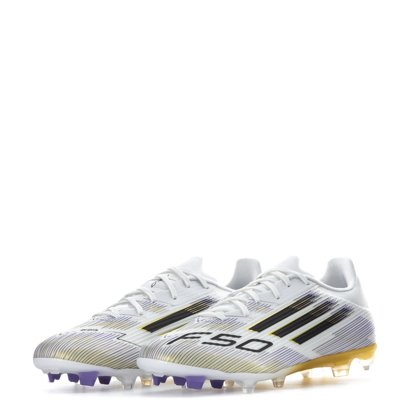 White football cleats with black and gold panel pattern, purple FG studs on outsole.