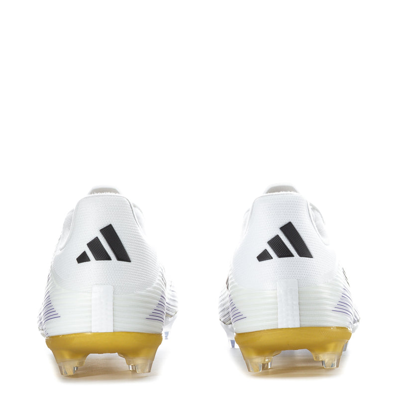 White football cleats heel and back, black logo marks, gold outsole with studs.