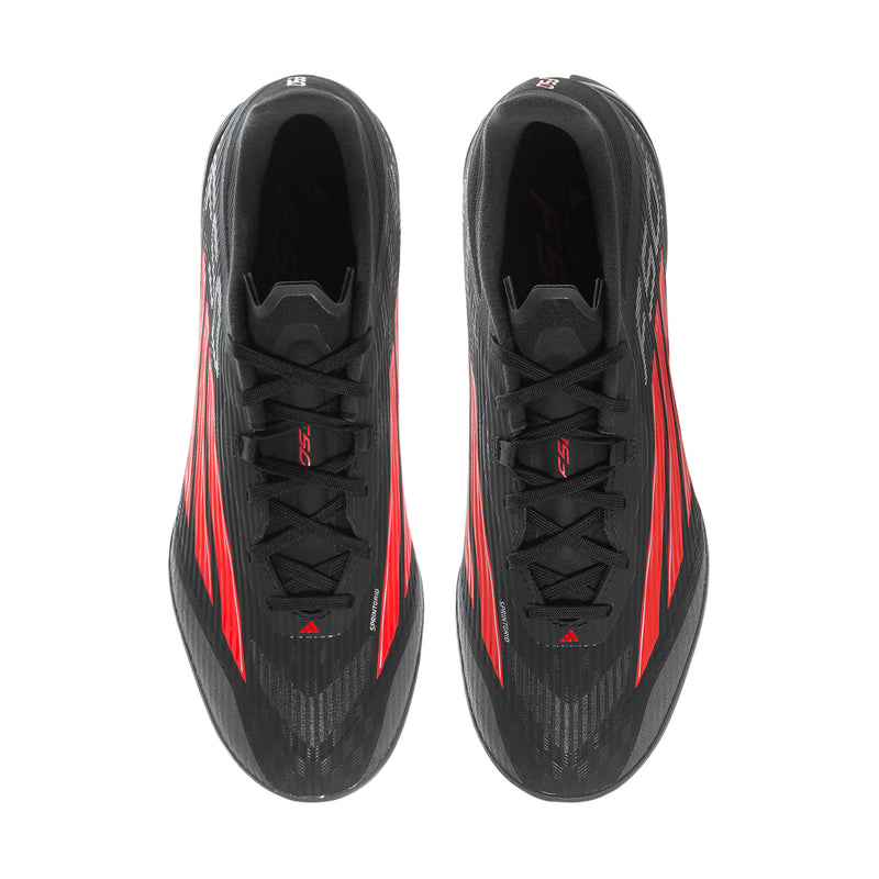 Pair of black soccer cleats viewed from above with red stripe accents.
