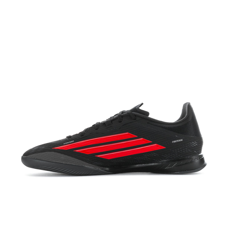 Black soccer cleat with red center stripes and lace-up opening.