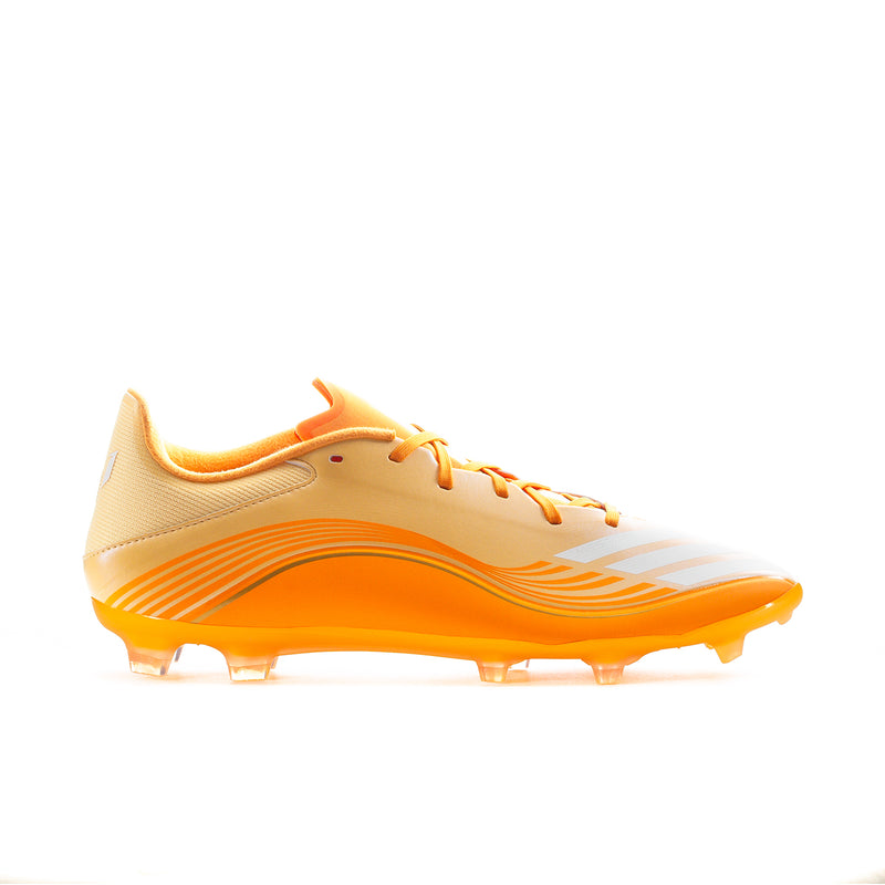 Men's low-top soccer cleats in cream and orange with orange studded sole