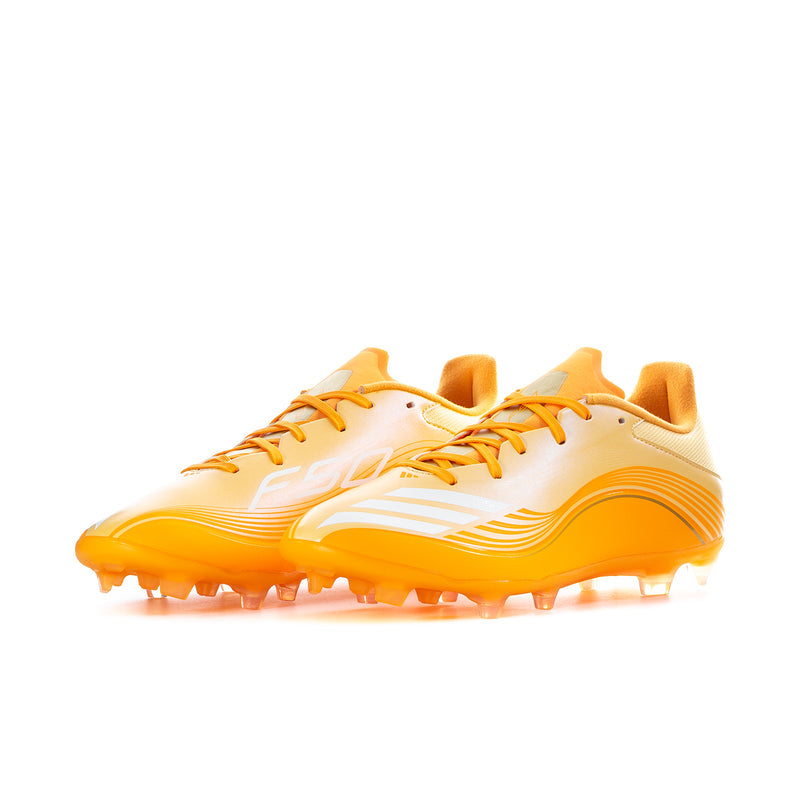 Men's low-top soccer cleats, cream upper with bright orange laces and studded sole