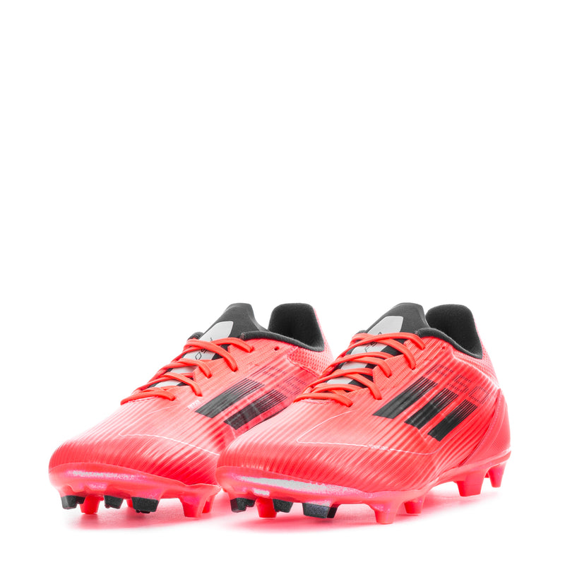 Pair of red men's football cleats with black stripes, orange laces, and FG studs.