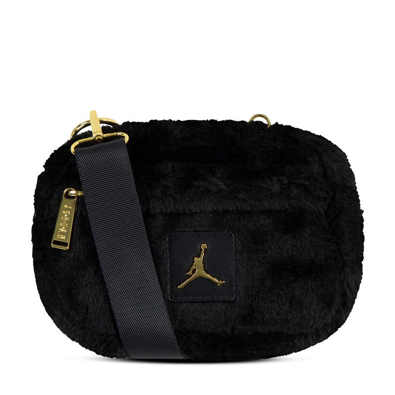 Black faux fur camera bag with gold Jumpman logo patch, flap front and crossbody strap