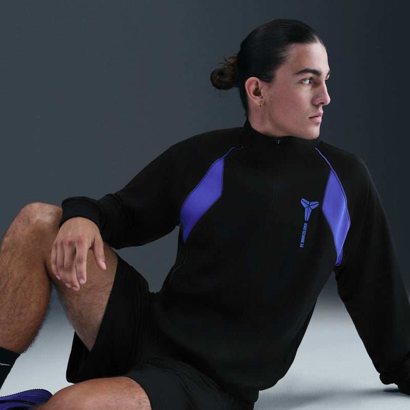 Men's black zip track jacket with purple shoulder panels and chest logo