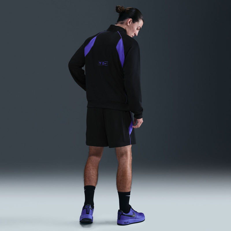Men's black zip track jacket with purple back panel and small logo on sleeve