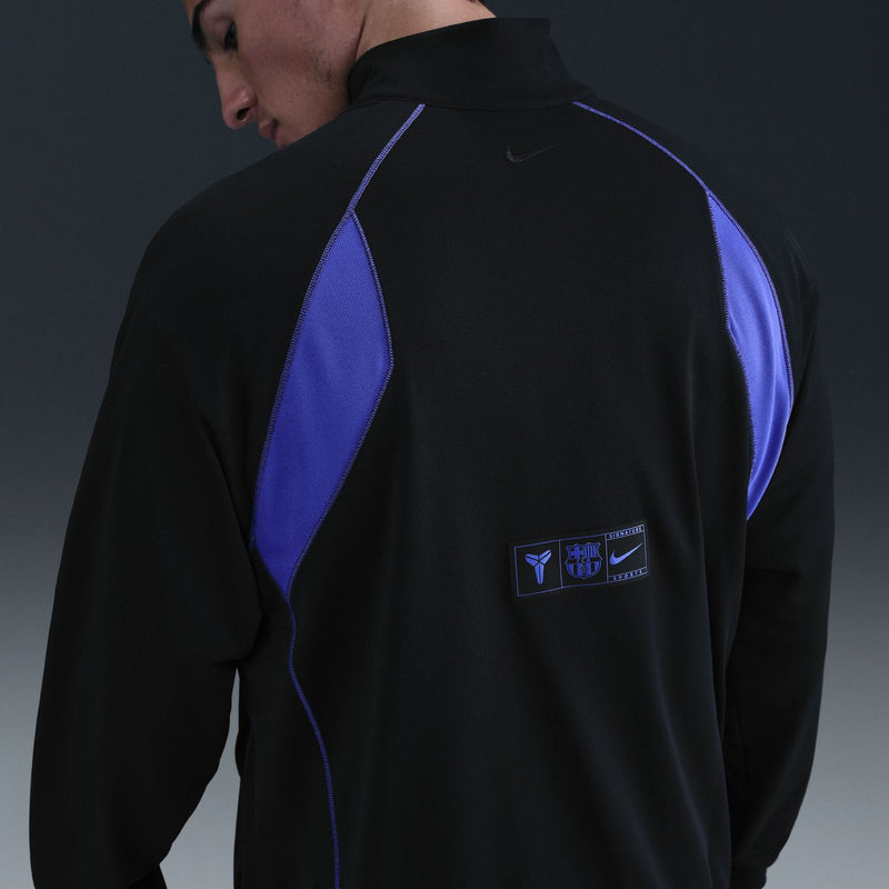 Men's black zip track jacket with purple back stripe and rectangular back logo patch