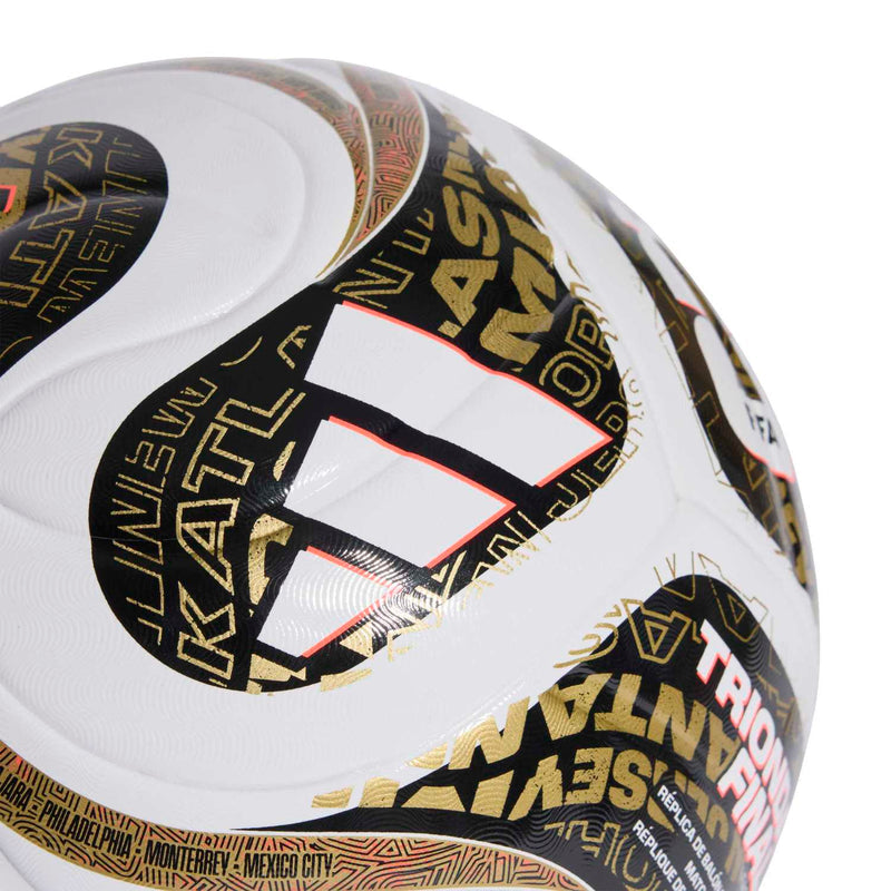 Close-up of white soccer ball with gold and black Trionda finals design