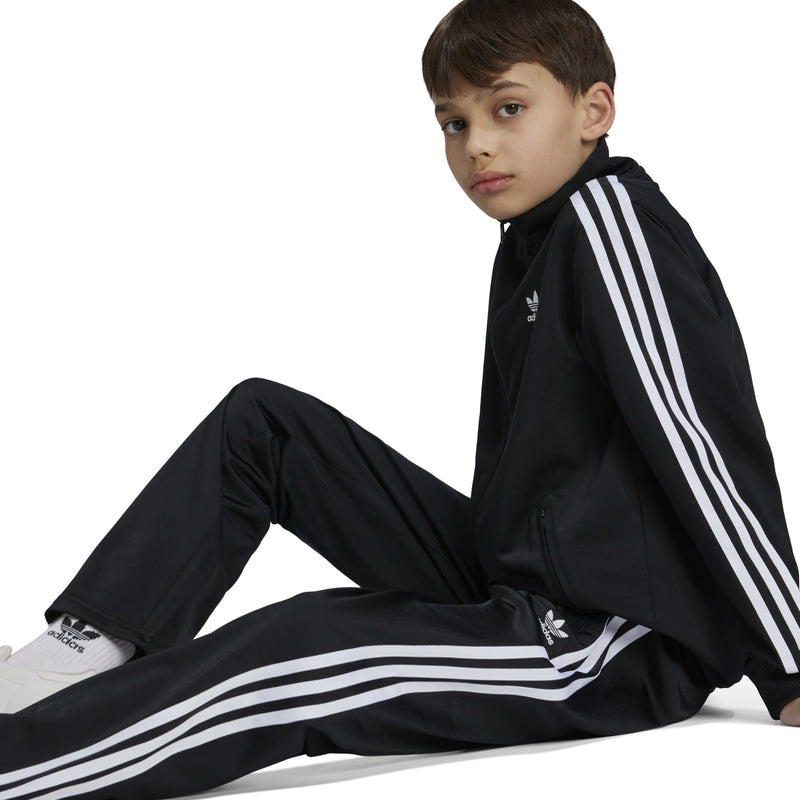 Youth black track pants with bold white side stripes and tapered leg opening