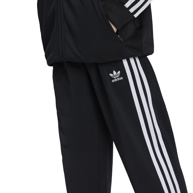 Youth black track pants with adidas logo and white vertical side stripes