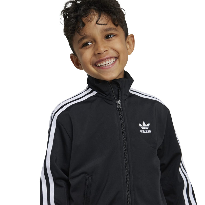 Kids black track jacket with white shoulder stripes, adidas logo, and zip front
