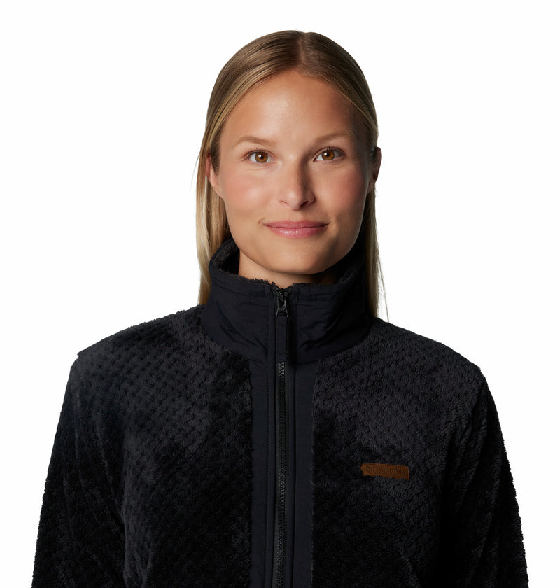 Women's black full-zip fleece jacket close-up, tan logo patch on chest