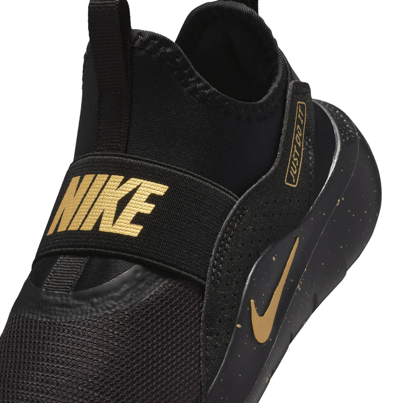 Kids' black slip-on sneaker close-up with gold label and textured mesh upper