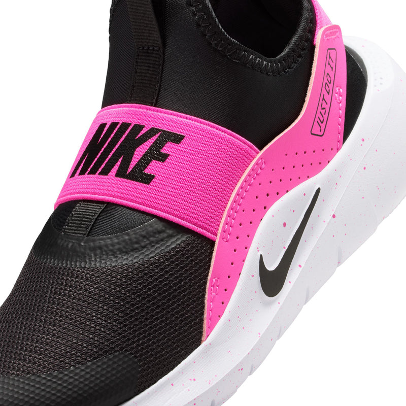 Kids slip-on shoe close-up: black knit upper with laser fuchsia strap and white swoosh.