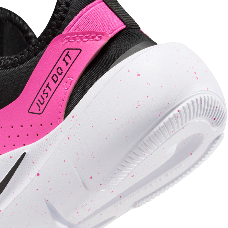 Kids shoe side close-up: black upper, laser fuchsia strap, speckled white foam sole.