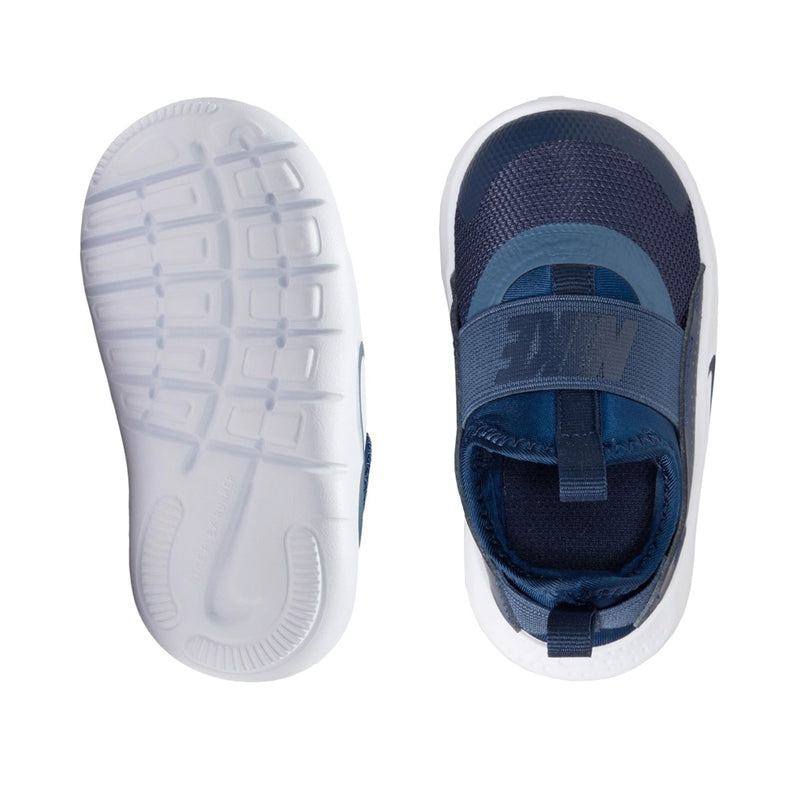 Toddler shoes viewed from soles: white traction outsole and dark blue upper with strap