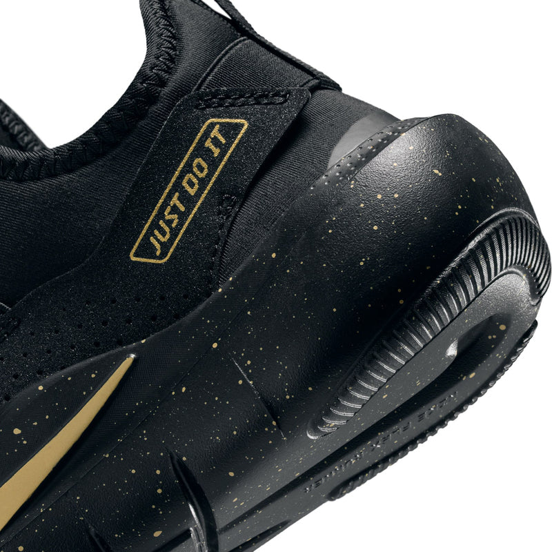 Youth black running shoe toe and midsole close-up with gold speckle detail