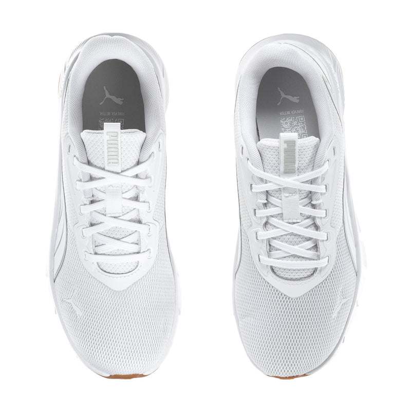 White lace-up running shoes for women, tongue and eyelets close-up, gum sole