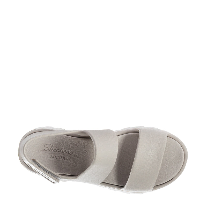 Women’s foam slide sandal, inside view, light neutral footbed with logo text