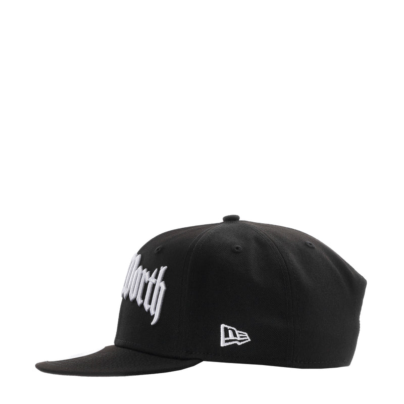 Black baseball cap with white logo and New Era flag patch