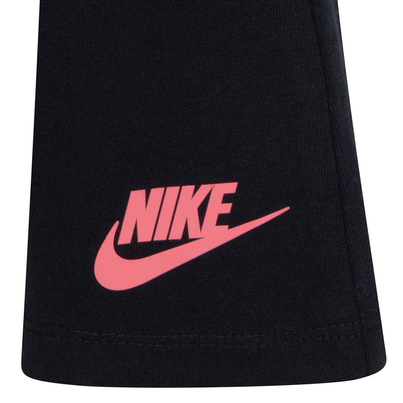 Kids black leggings with red Nike logo near hem