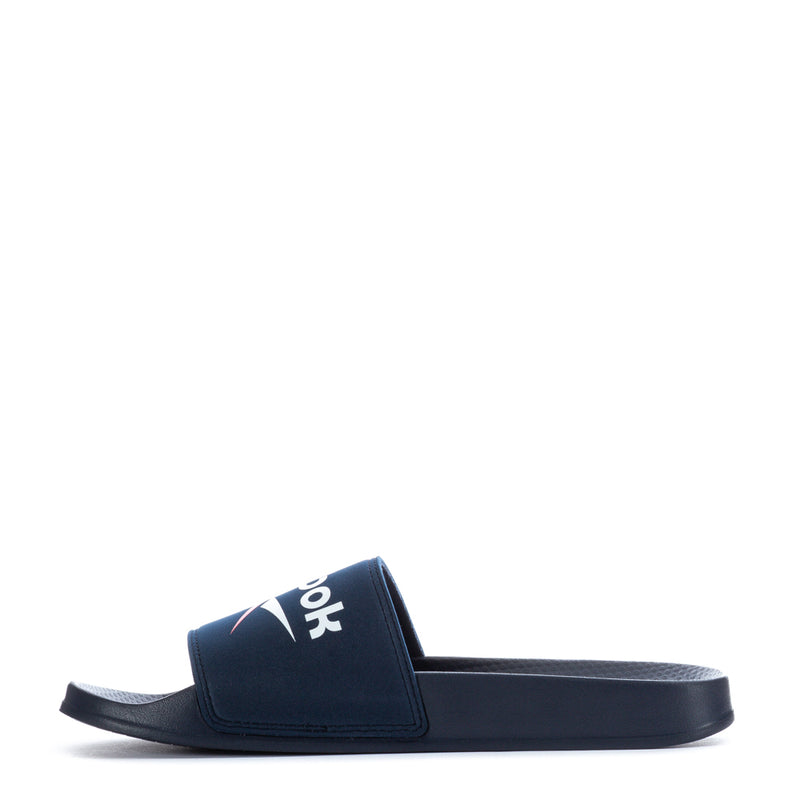 Men's navy slide sandals with wide strap and Reebok branding across the top