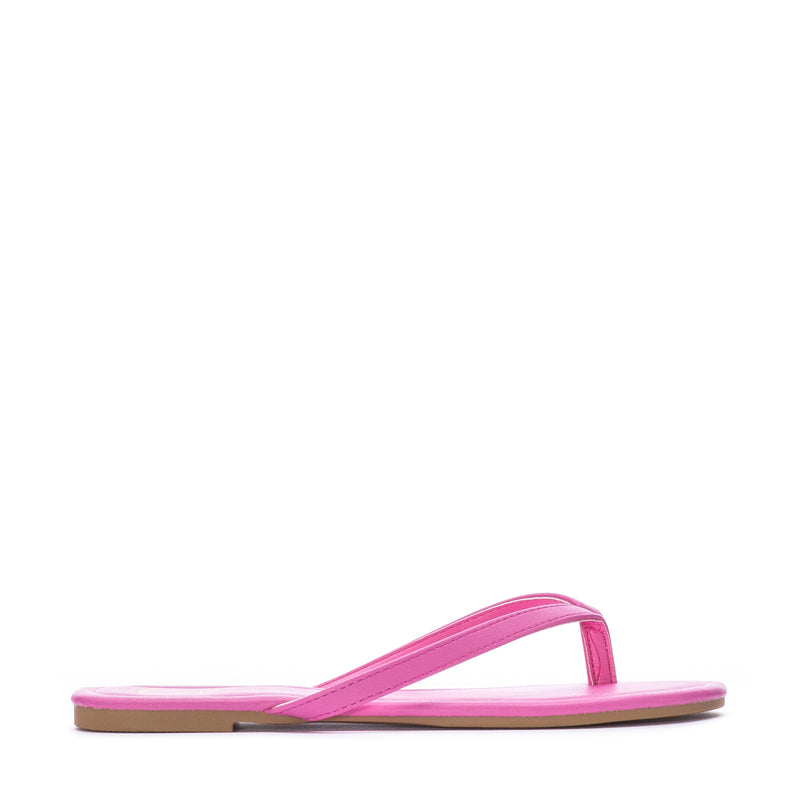 Women's fuchsia flip-flop sandals with thong strap and flat slide sole