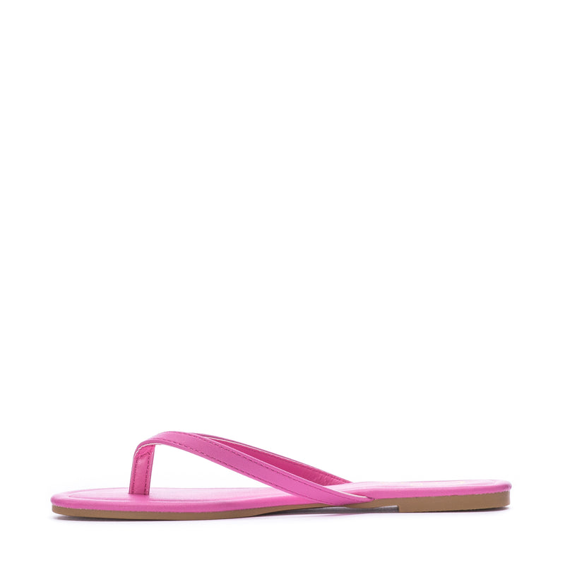 Women's fuchsia flip-flop sandals, side view with thong strap and flat footbed