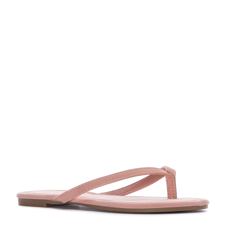 Women’s blush nubuck flip-flop sandals, side view with open toe thong