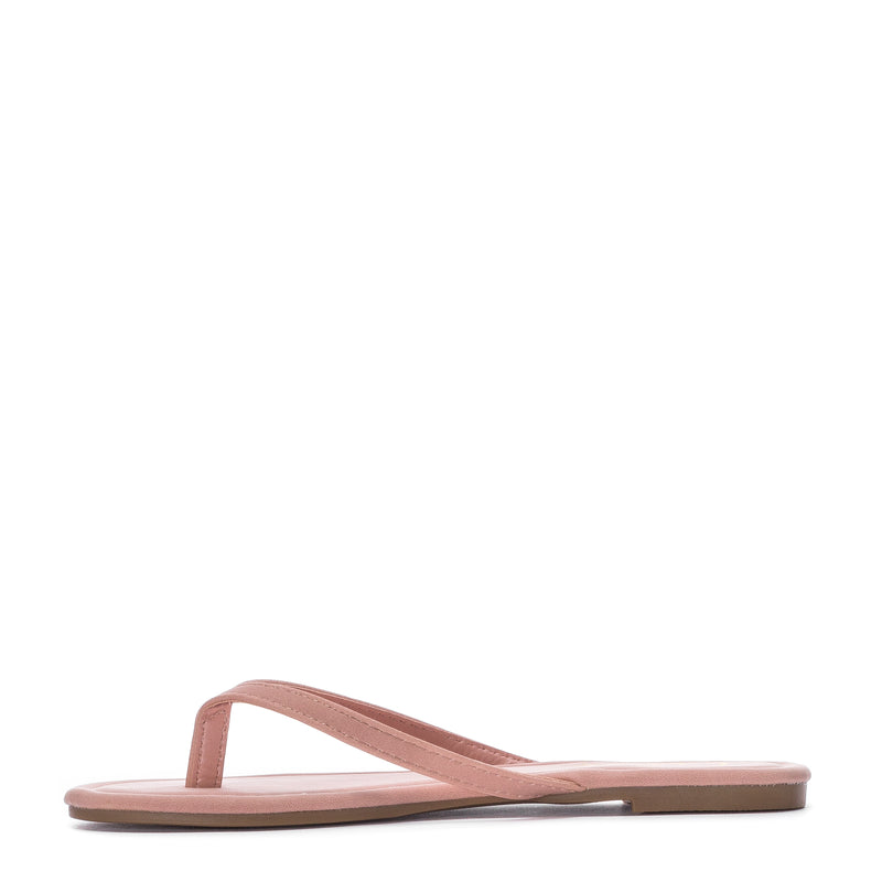 Women’s blush nubuck flip-flop sandals, angled view with padded footbed
