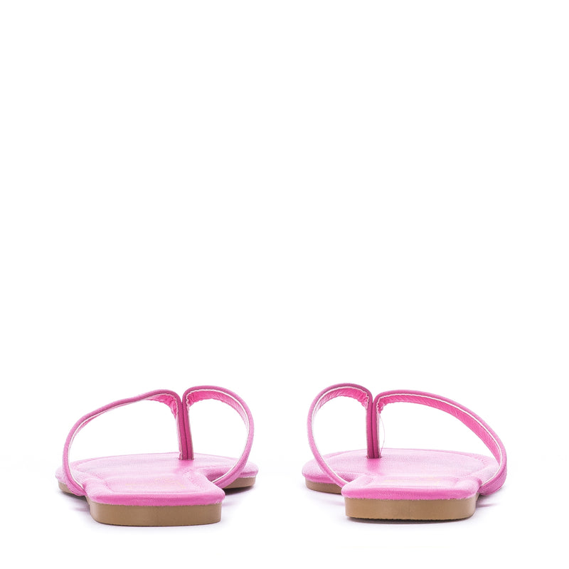 Pair of women's fuchsia flip-flop sandals with open toe and thong back strap