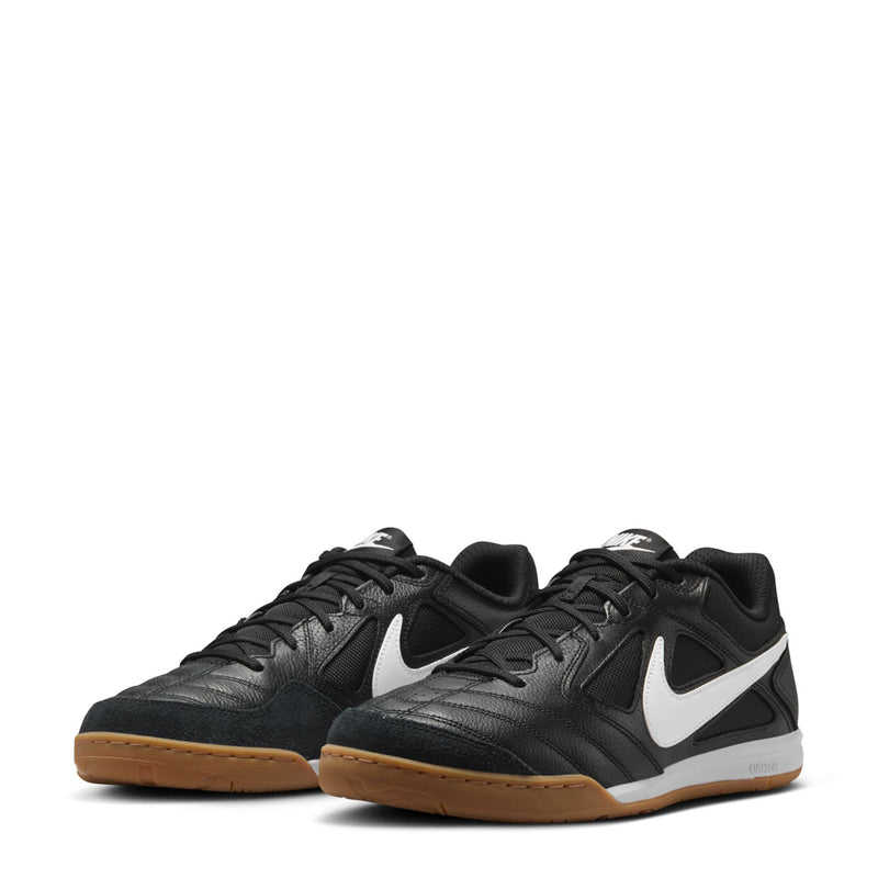 Pair of black men's soccer shoes with white swoosh and gum soles, lace-up