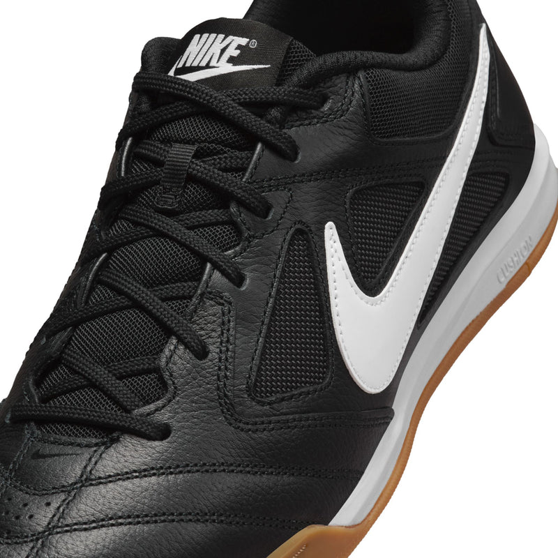 Black men's soccer shoe close-up with Nike tongue label and white swoosh stripe