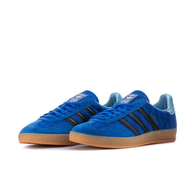 Pair of men's blue indoor sneakers with black stripes and gum rubber sole