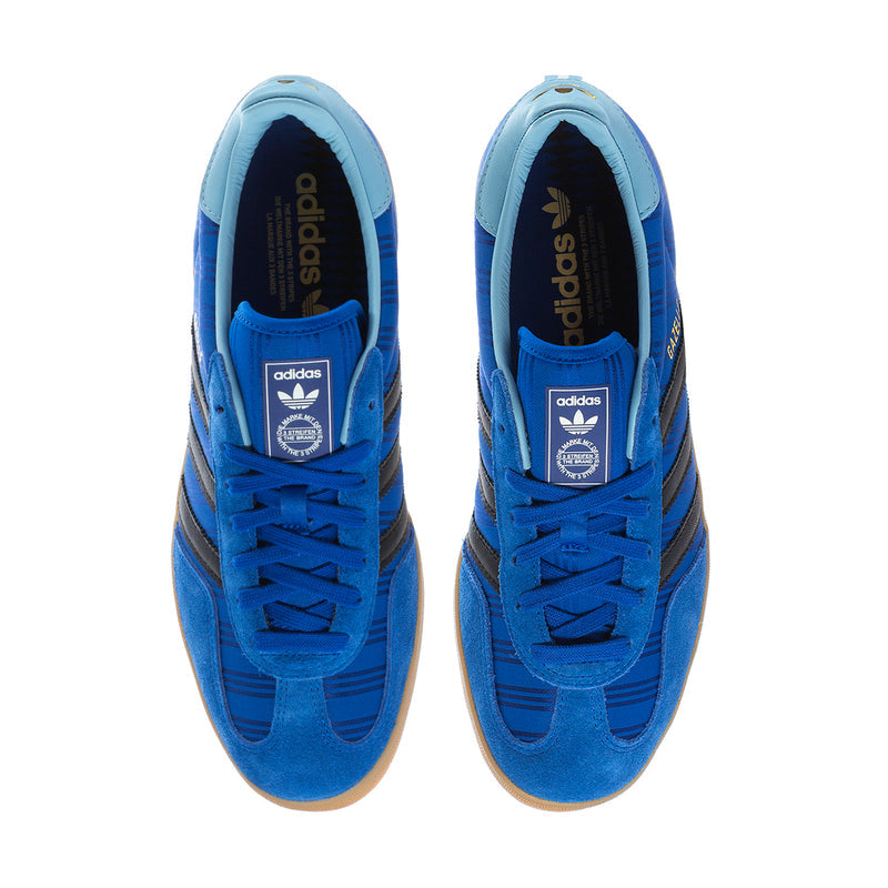 Men's blue indoor sneakers showing tongues and adidas logo at the inner collar