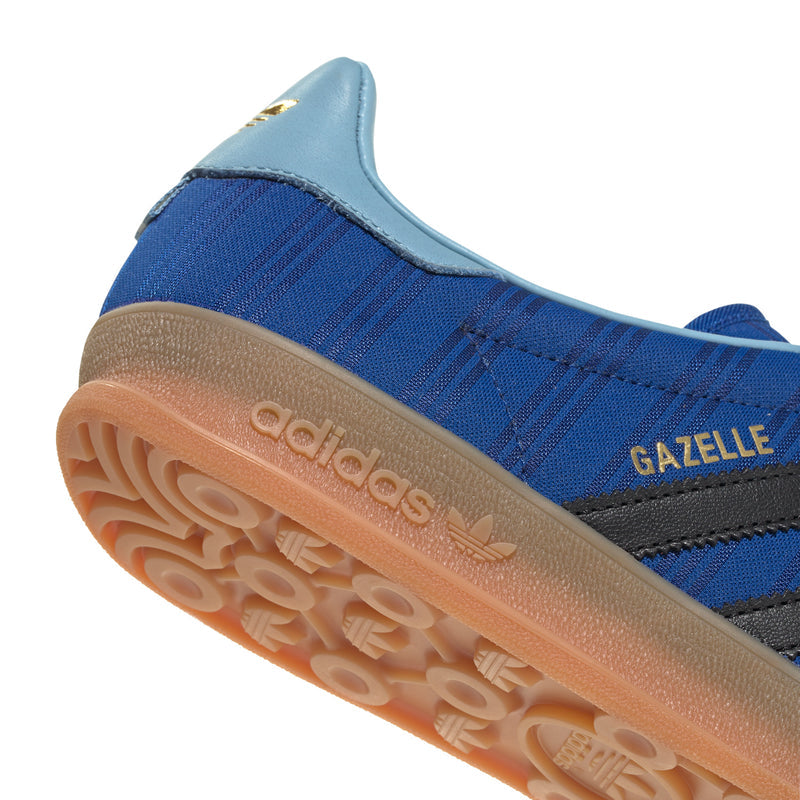 Blue indoor sneaker sole close-up with GAZELLE side text and rubber tread