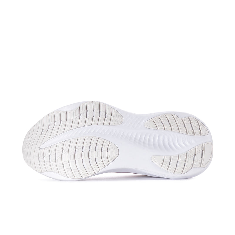White women’s sneaker outsole with textured tread and segmented grip pattern