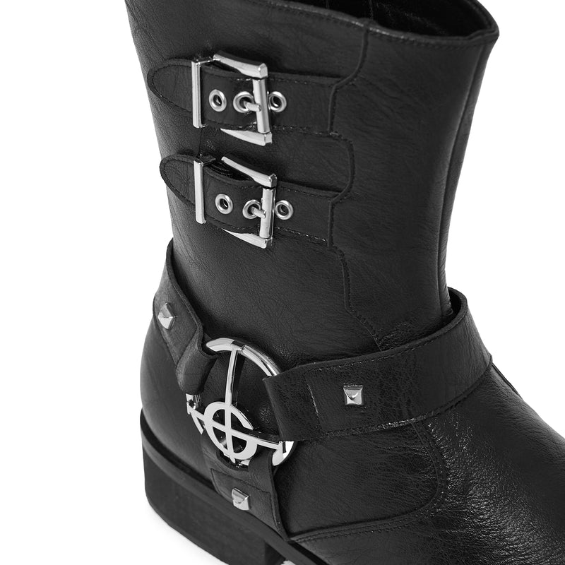 Black leather boot with metal buckles on a white background